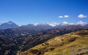a landscape of a valley with mountains in the background